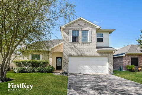 a white brick house with a white garage door
