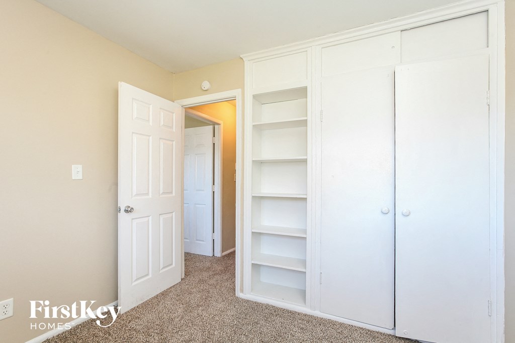 the closet in the master bedroom of this fixer upper house