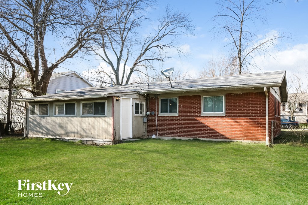 a brick house with a white garage door and a roof