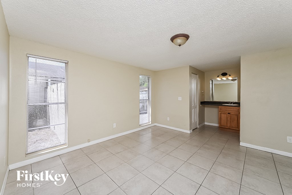 the living room and dining room of an empty house