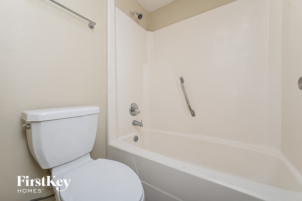 a bathroom with a tub and a toilet and a sink