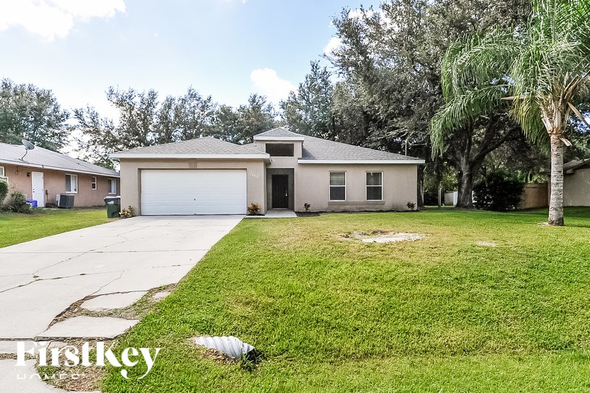 A house with a garage and a driveway is for sale.