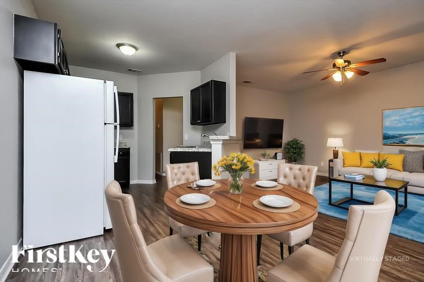 A dining room with a wooden table set for four.