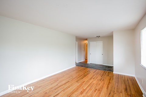 A room with wooden floors and white walls.
