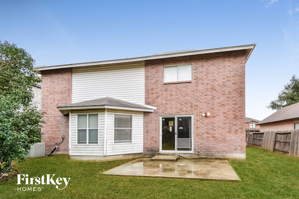 the exterior of a brick house with a yard and grass