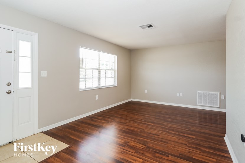 A room with wooden floors and a white door.