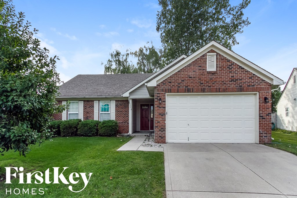 A brick house with a garage door is for sale by FirstKey Homes.
