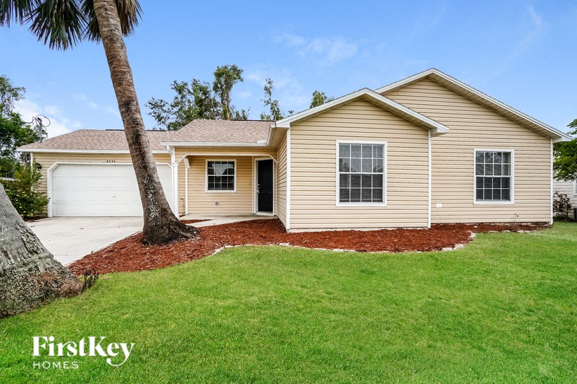 A house with a palm tree in front of it.