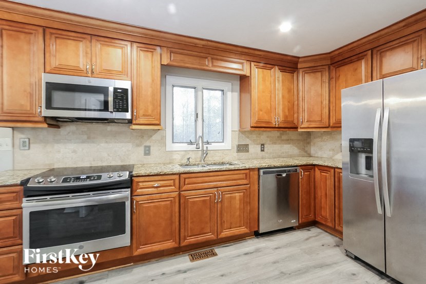 A kitchen with wooden cabinets and stainless steel appliances.