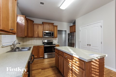 A kitchen with wooden cabinets and a white countertop.