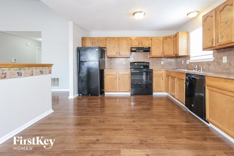 a kitchen with black appliances and wooden cabinets