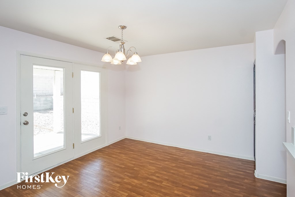 a living room with a wood floor and white walls