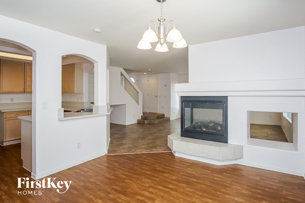 a living room with a fireplace and a hard wood floor