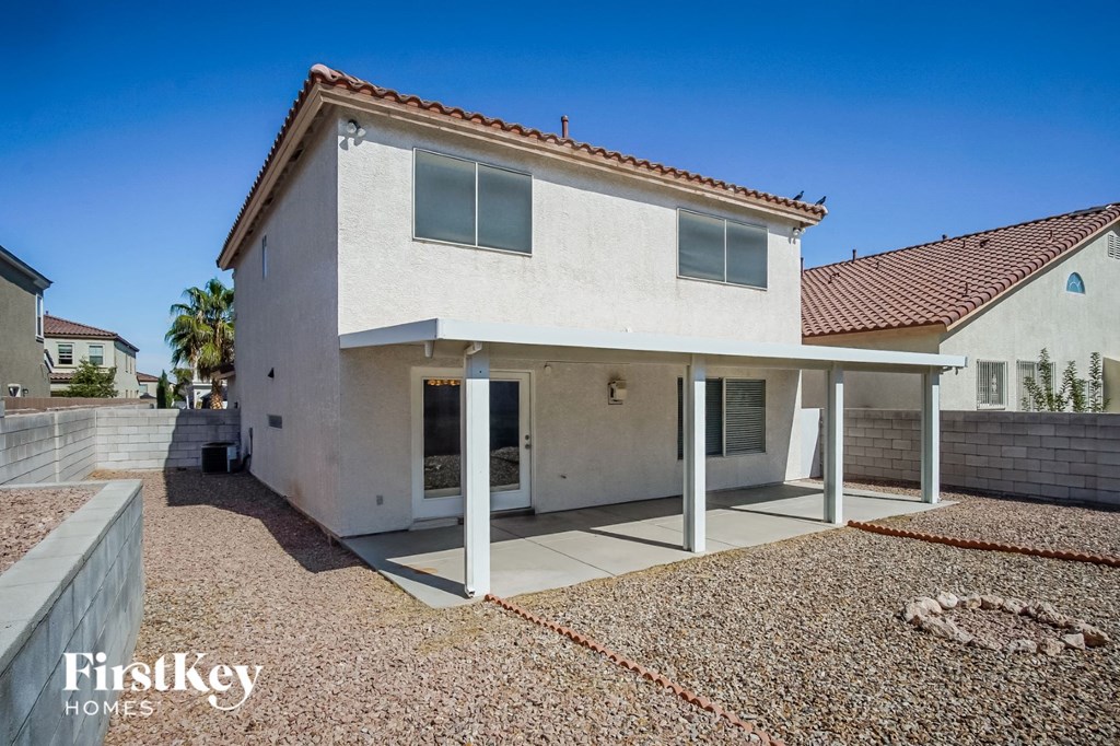 a white house with a patio and a driveway