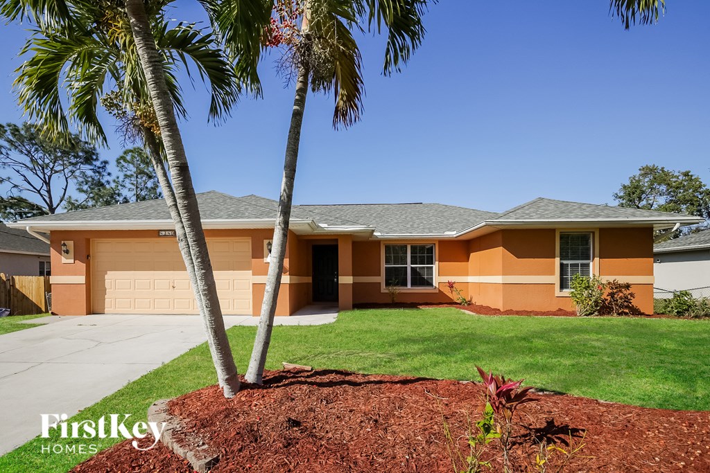 a house with palm trees in front of it