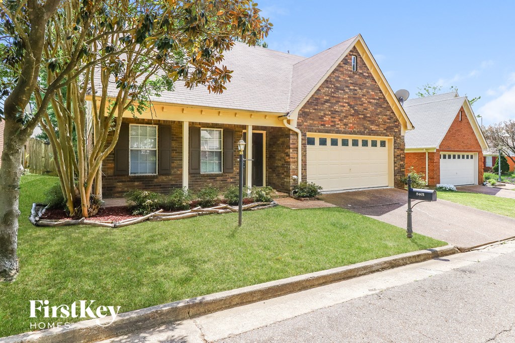 a small brick house with a yellow roof and a white garage door