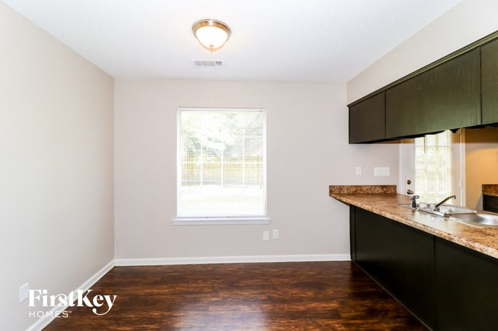 an empty kitchen with a sink and a window