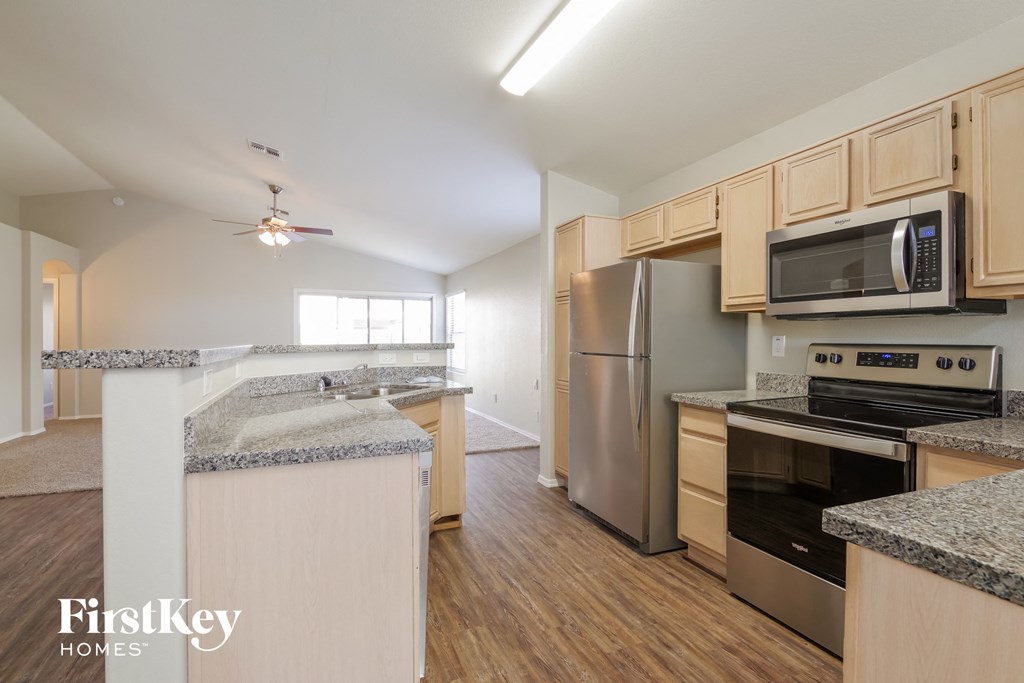 a kitchen with granite counter tops and stainless steel appliances