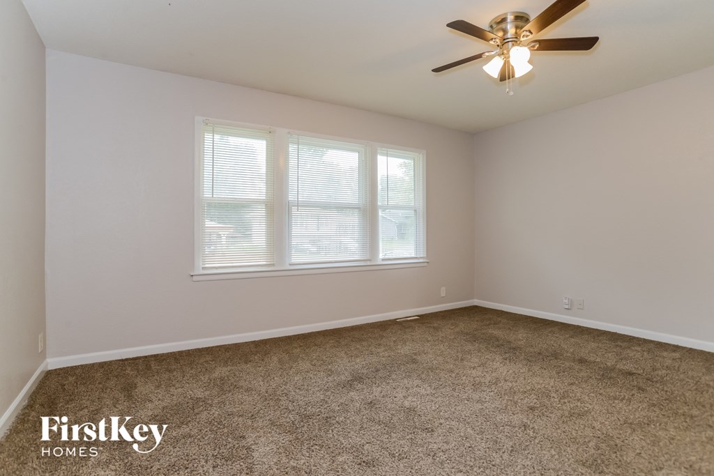 a bedroom with carpet and a ceiling fan