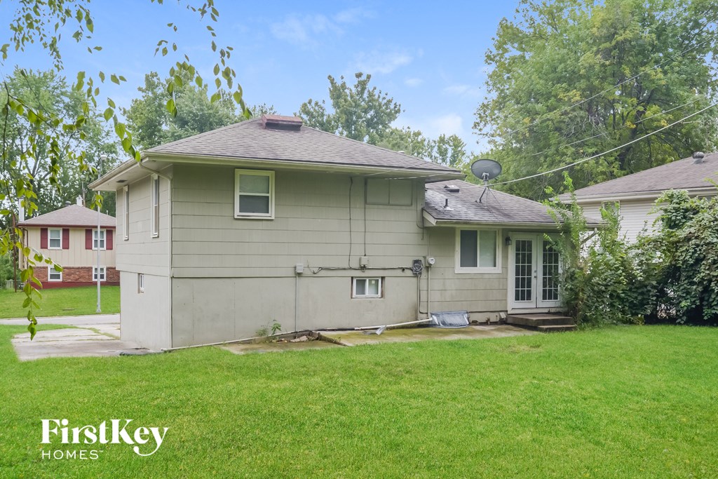 a white house with a yard and a lawn