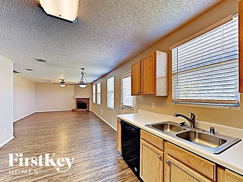 A kitchen with wooden cabinets and a sink.
