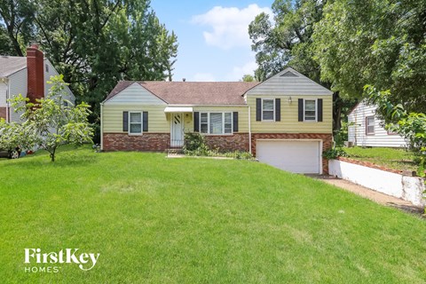 a home with a lawn and a garage