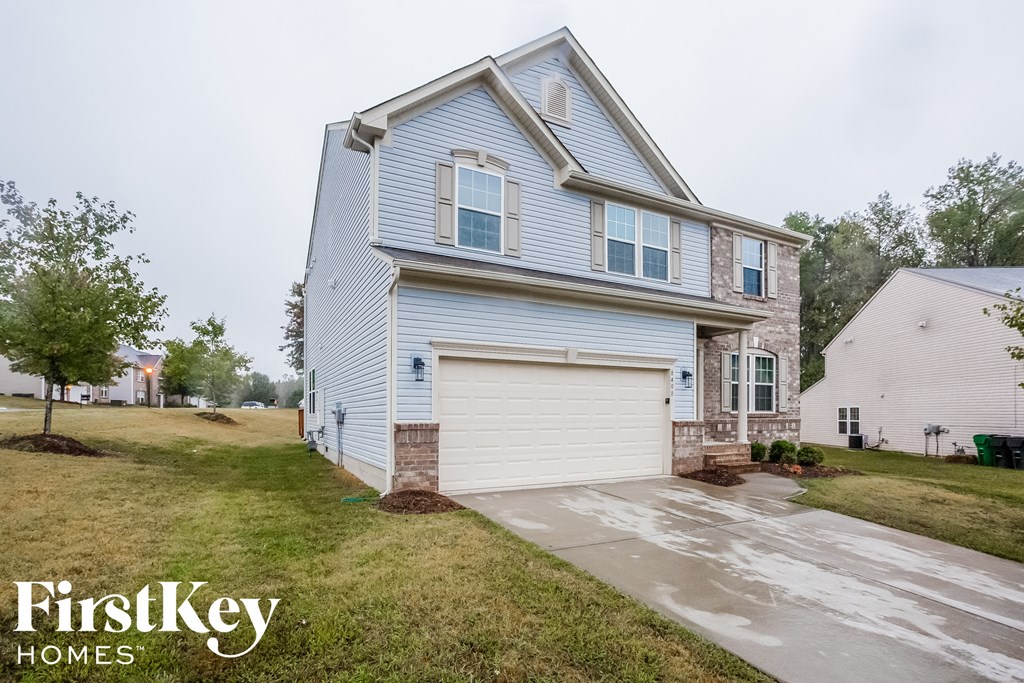 a blue and white house with a white garage door