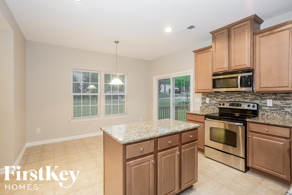 a kitchen with wooden cabinets and stainless steel appliances
