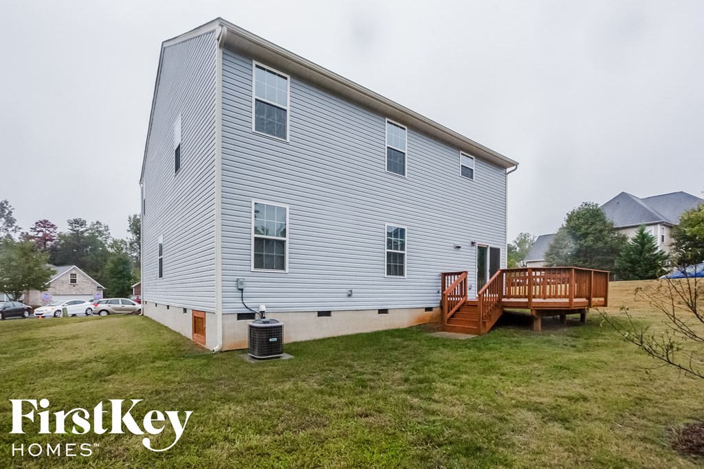 a white house with a deck and a wood deck