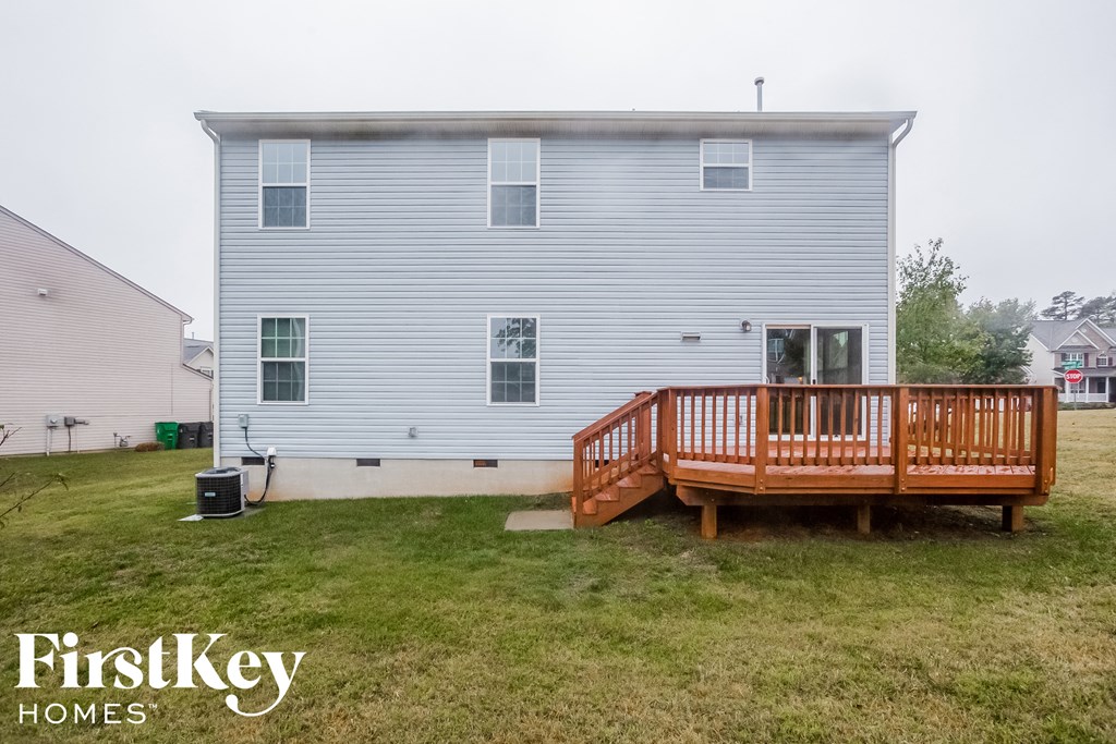 the back of a house with a wooden deck