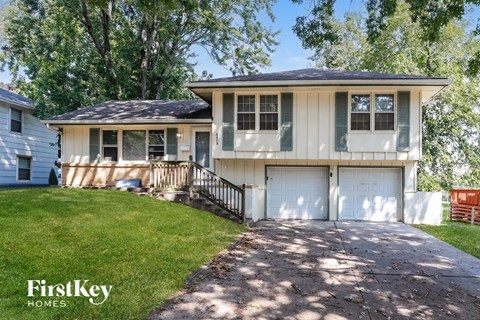 A two-story house with a garage is for sale.