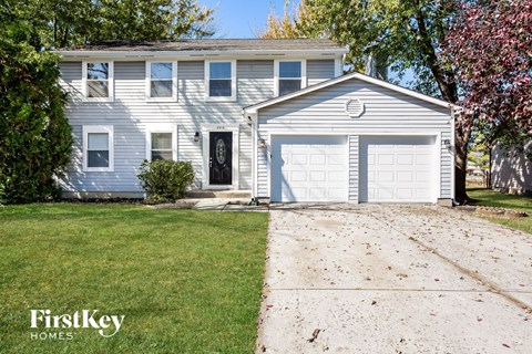 a blue and white house with a white garage door