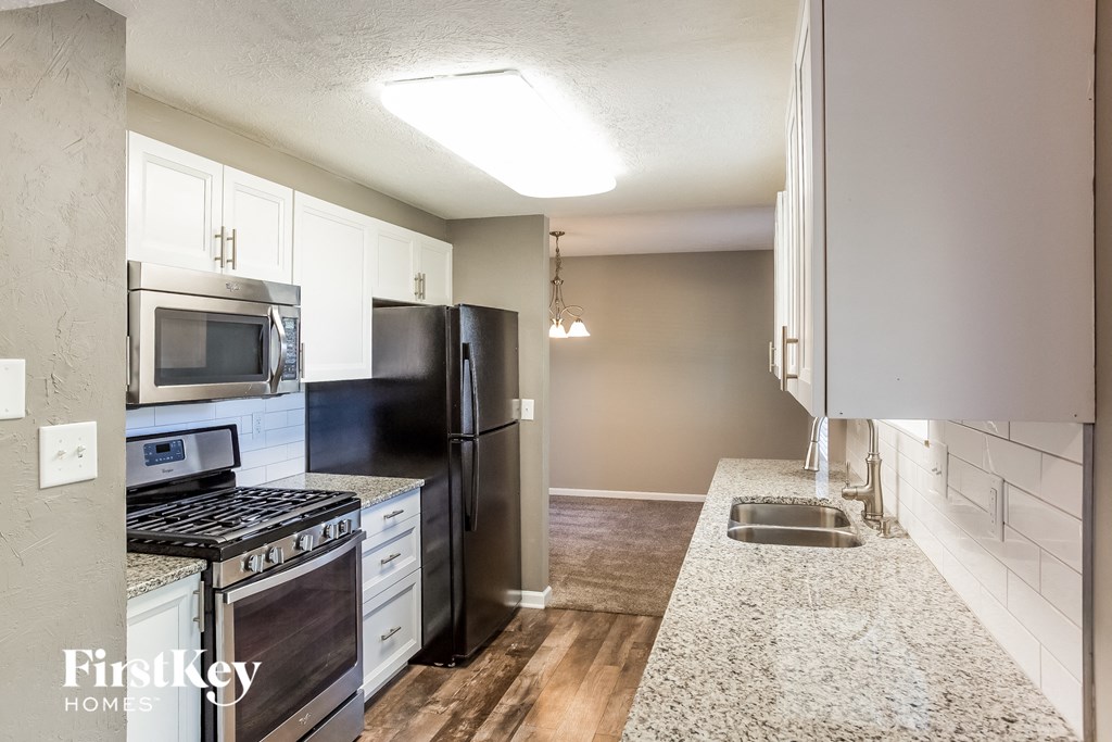 a kitchen with granite counter tops and stainless steel appliances