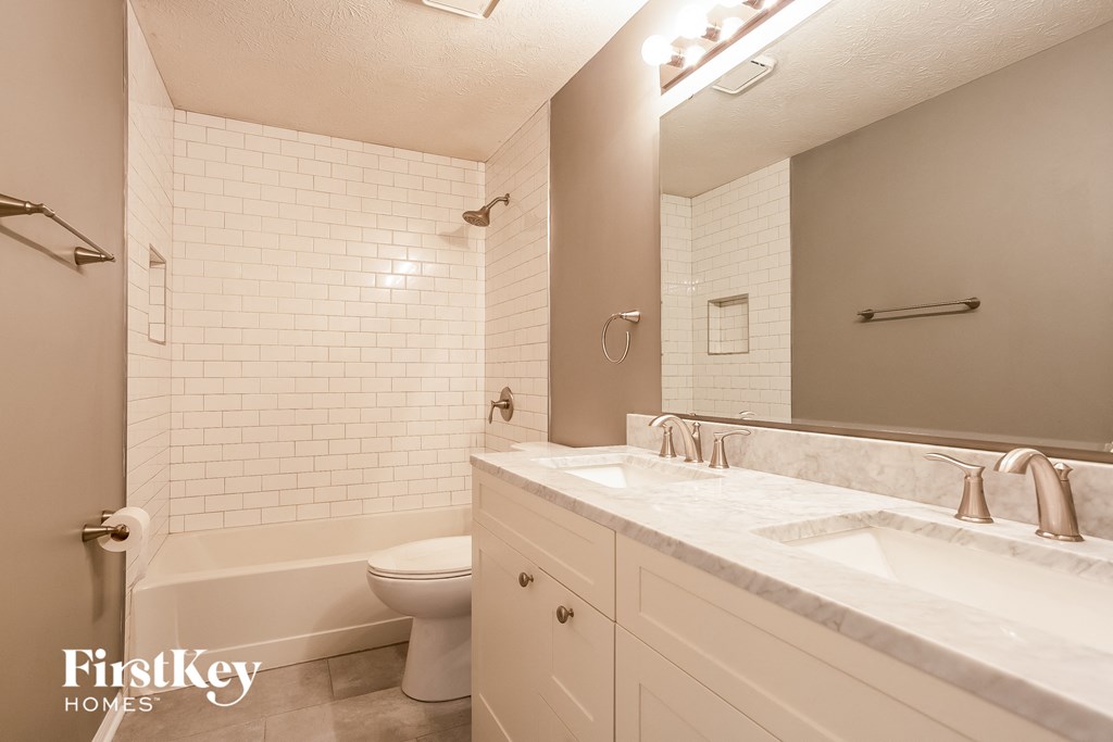 a bathroom with a sink and a toilet and a bath tub