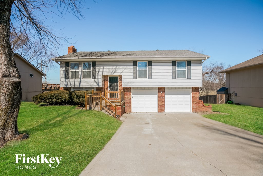 a white house with a garage and a driveway