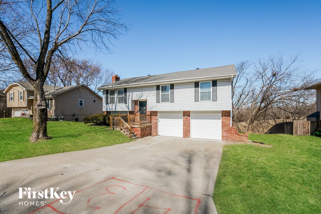 a white house with a garage and a driveway
