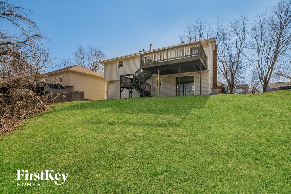 a home with a deck on top of a hill