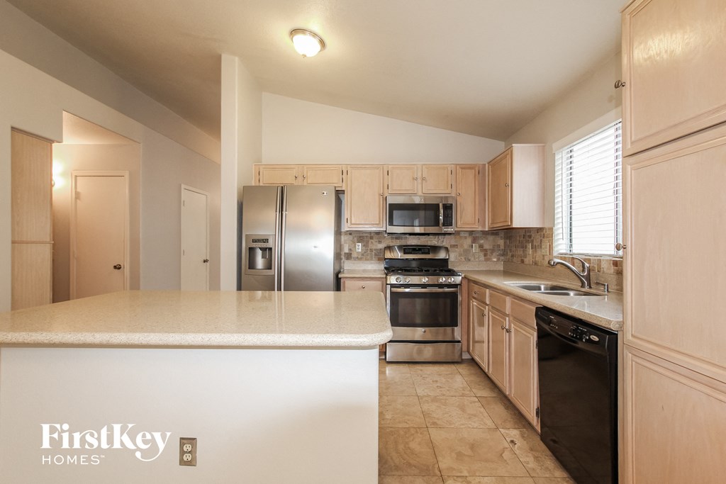 A kitchen with a FirstKey Homes logo on the island.