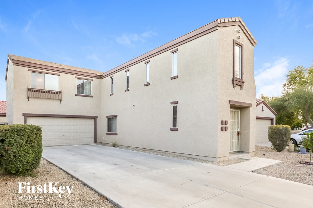 a white house with a driveway and a garage door