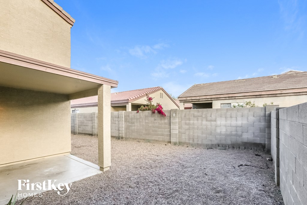 a backyard with a fence and a house