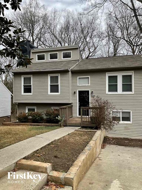A grey house with a white door and windows.