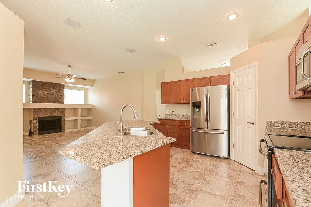 a kitchen with granite counter tops and stainless steel appliances