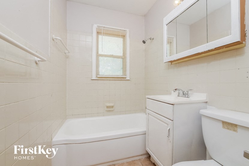 a bathroom with a sink toilet and a bath tub