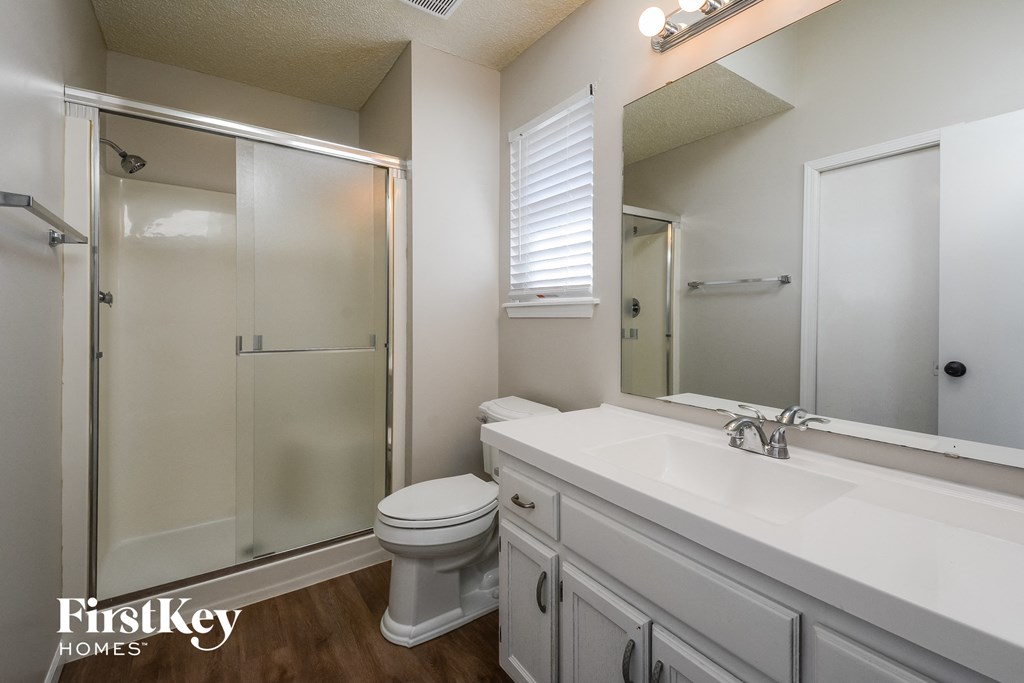a bathroom with a sink toilet and a shower