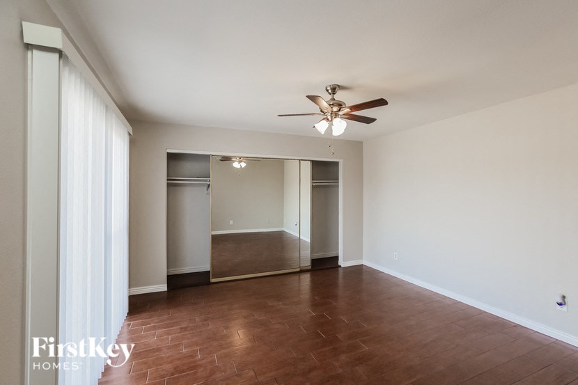 a empty living room with a ceiling fan
