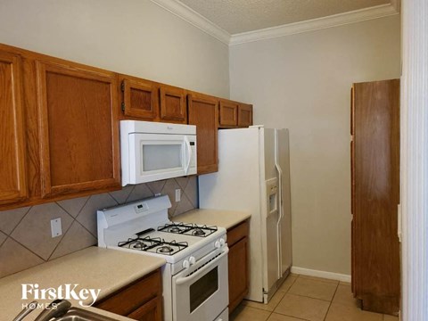 a kitchen with a stove microwave and refrigerator