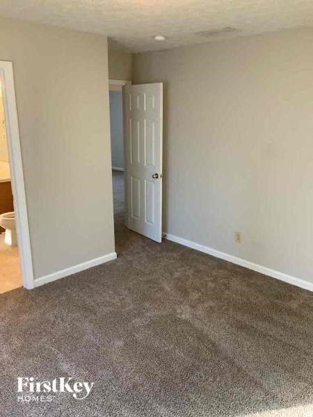 a room with a carpeted floor and a white door