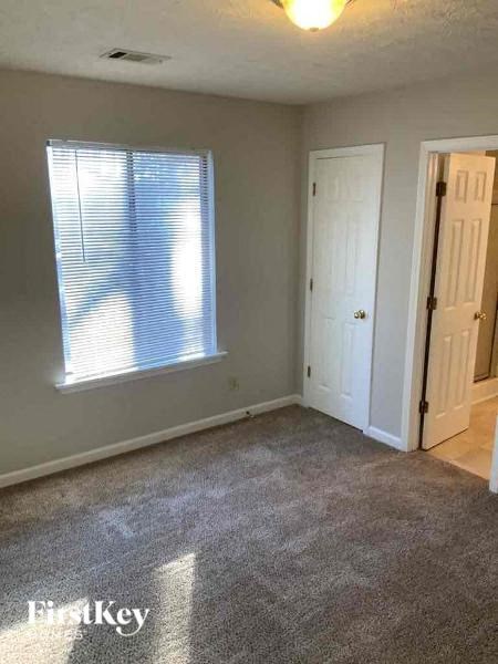 an empty room with a window and a door