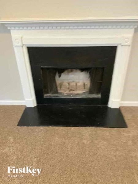 a fireplace in a living room with a cake in it