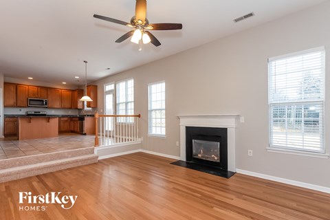 A spacious living room with a fireplace and a television.